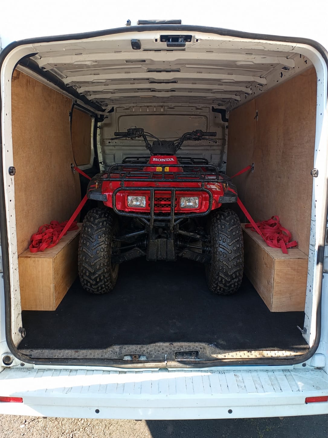Motorbike being strapped for transit