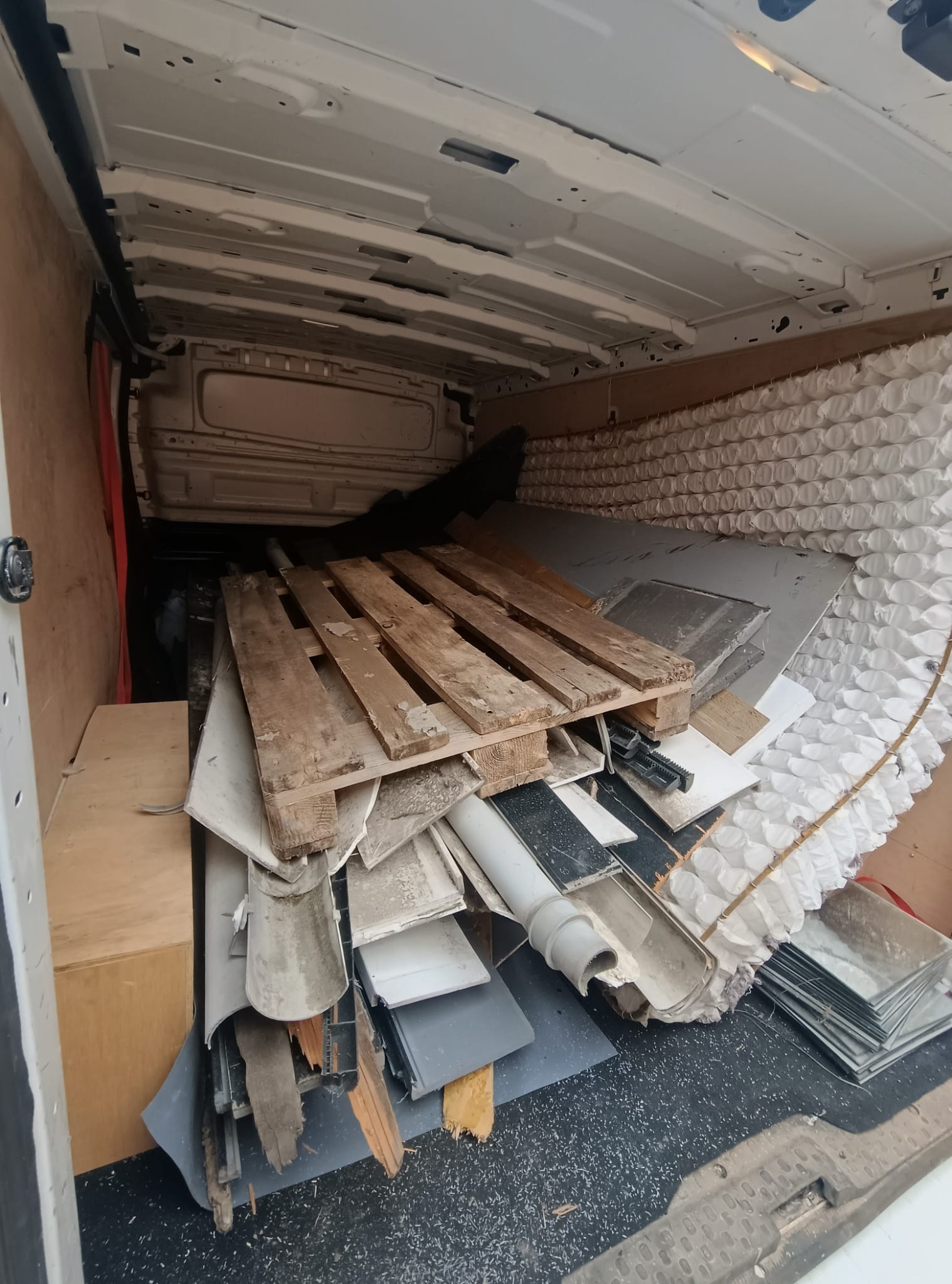Waste removal van collecting furniture